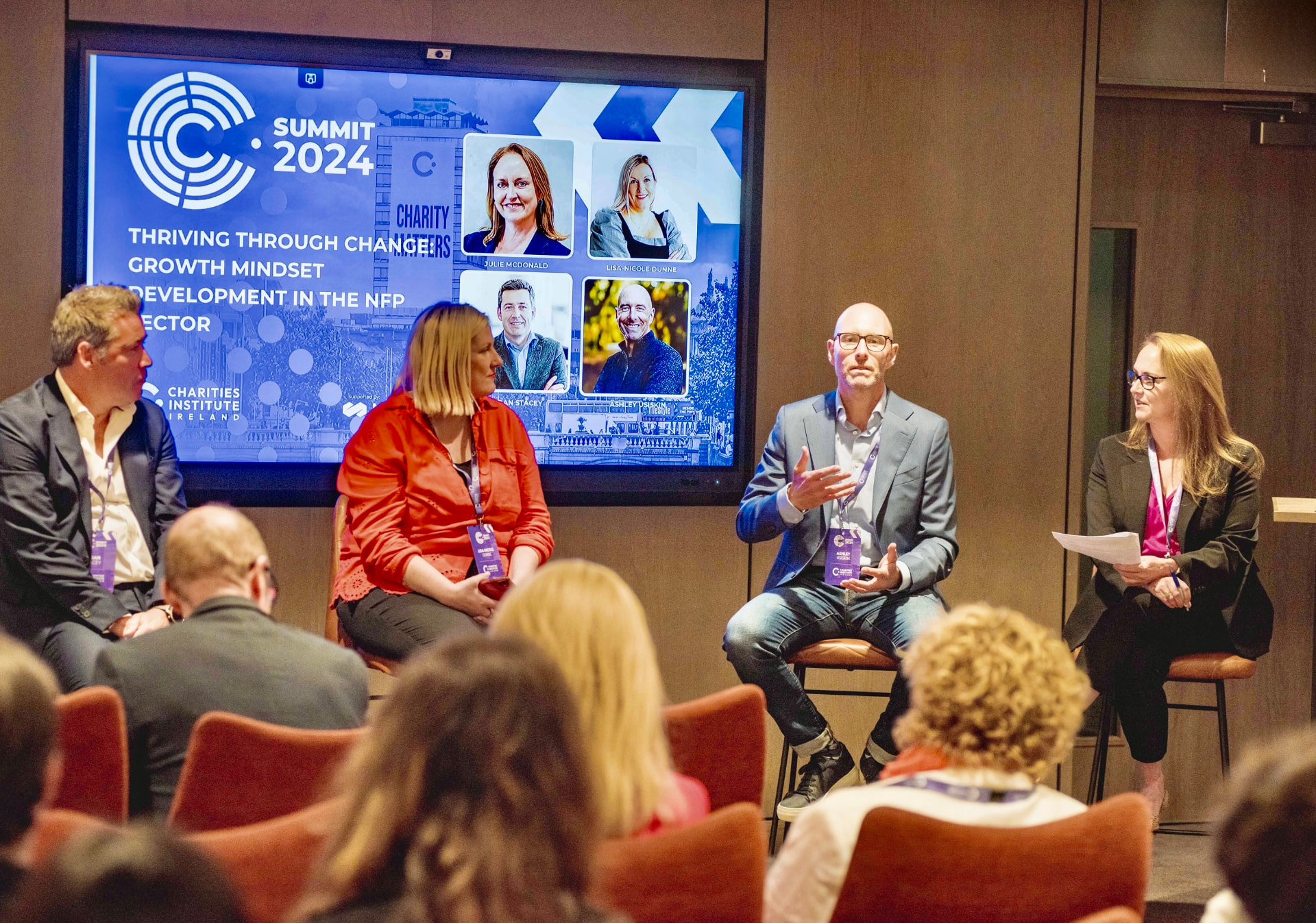 Ashley Usiskin speaking on a panel discussion about growth mindset in front of a seated audience